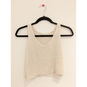 A beige, knit, cropped tank
